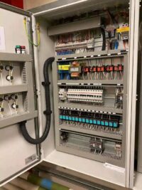 An image of a spacious electrical panel filled with numerous wires and cables.